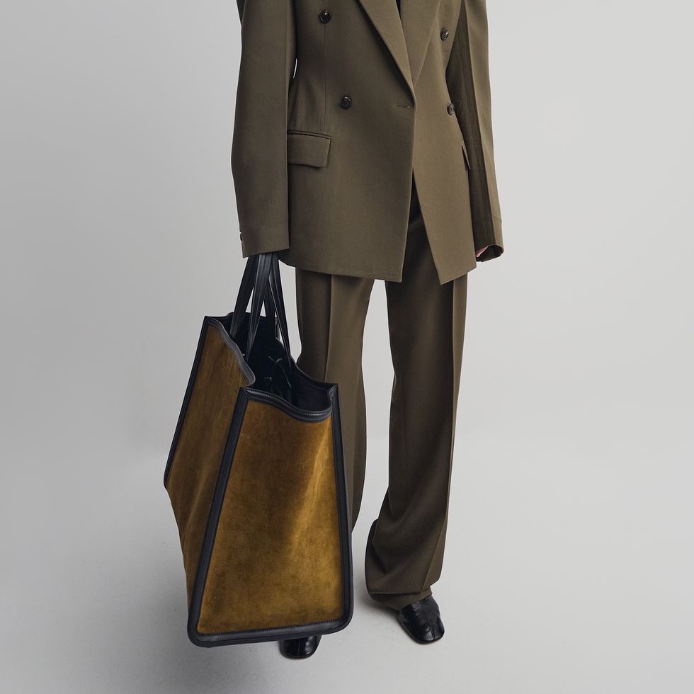 a brown suit with a black bag