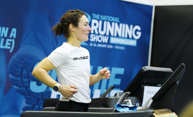runner demonstrating on a treadmill at a running show event