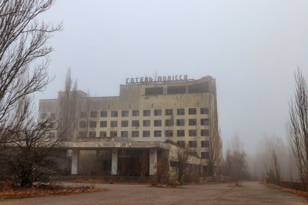abandoned building of polissya hotel in the ghost town pripyat in chernobyl exclusion zone, ukraine inscription in ukrainian hotel polissya