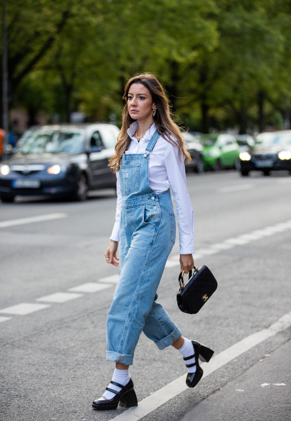 berlin, germany september 13 a guest is seen wearing denim overall, chanel bag, white socks, shoes during about you fashion week on september 13, 2021 in berlin, germany photo by christian vieriggetty images
