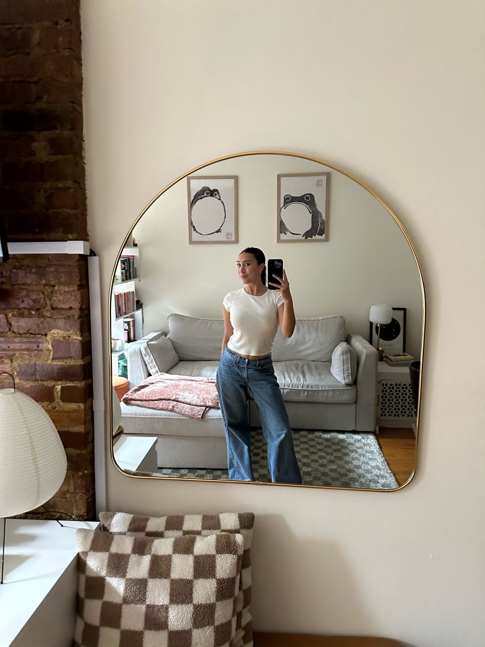a tester wearing abercrombie low rise baggy jeans and a white t shirt, good housekeeping's testing for the best jeans for women