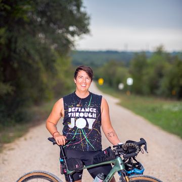abi robins standing with bike on gravel road