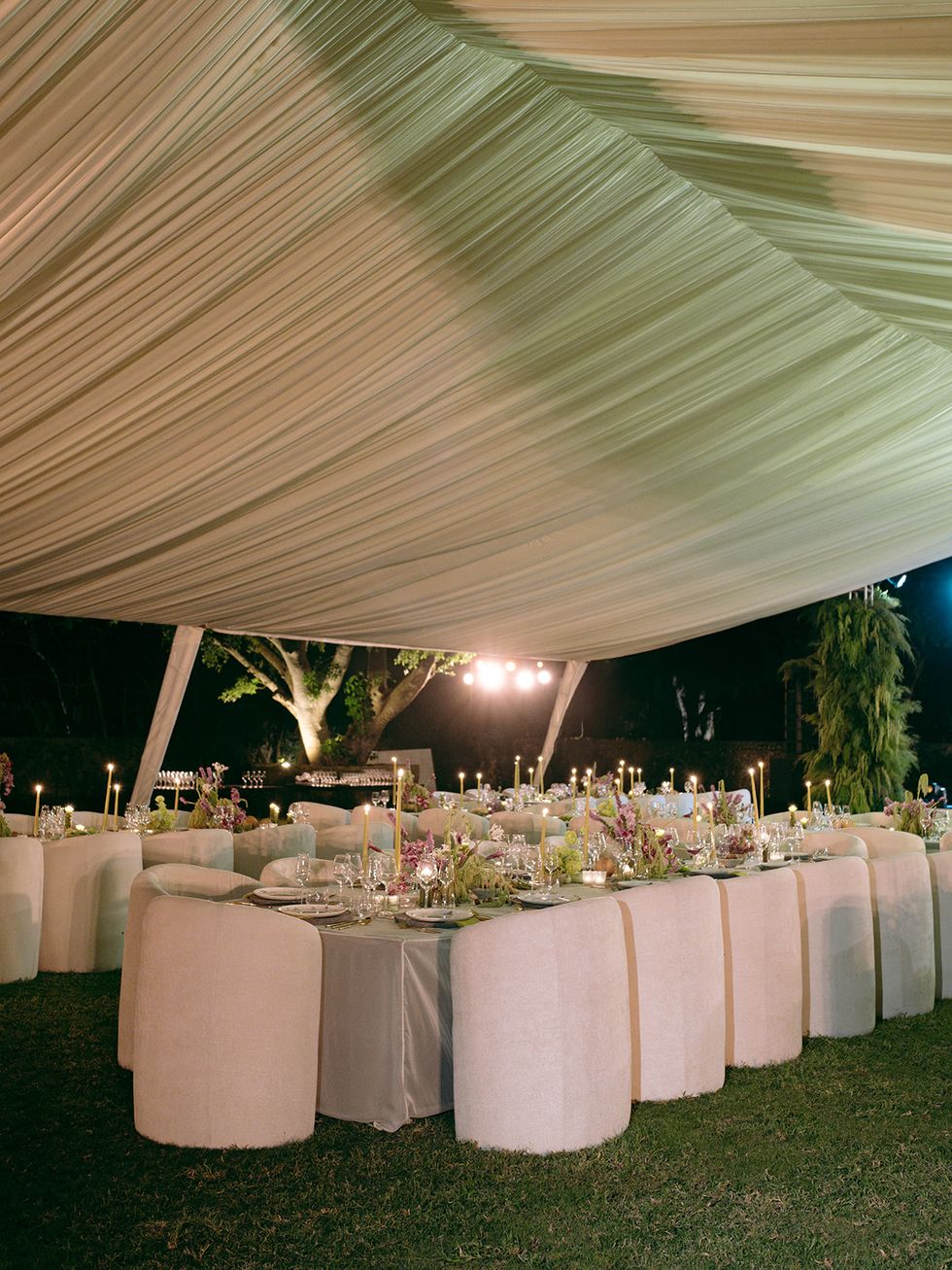 a set table with white cloths and white tables
