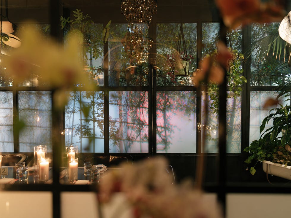 a group of people sitting at a table with candles and glasses