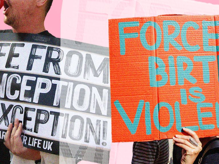 an anti abortion protestor holding a sign next to a pro choice protestor