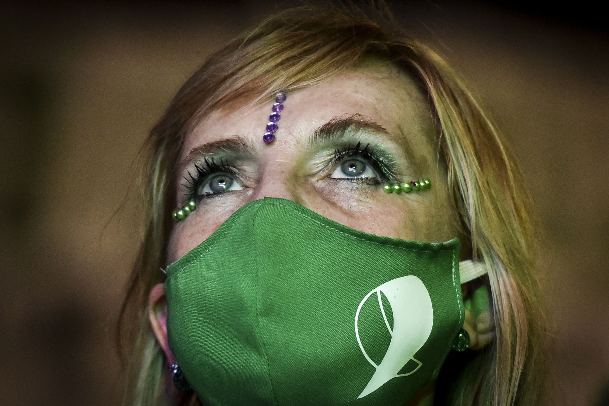 buenos aires, argentina   december 30 a pro choice demonstrator, wearing a face mask, waits outside the national congress as senators decide on legalization of abortion on december 29, 2020 in buenos aires, argentina the proposal authorizes legal, voluntary and free interruption of pregnancy until the 14th week while allowing doctor's conscientious objection it is the ninth bill to legalize abortion treated by the argentine congress and the first one publicly supported by the president of the country photo by marcelo endelligetty images