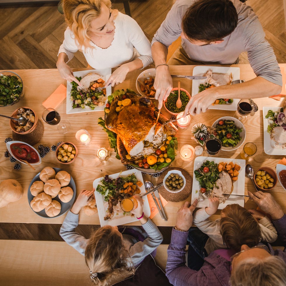 above view of extended family talking at thanksgiving dinner