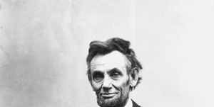 president abraham lincoln stares into the camera with a slight smile in this black and white photo, he wears a dark colored tuxedo