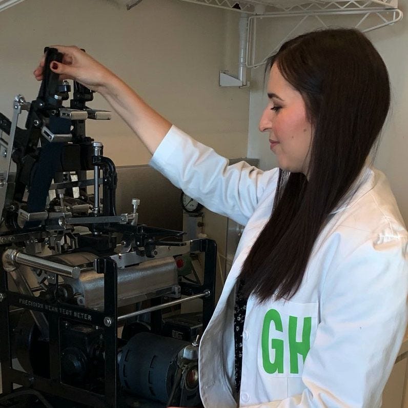a gh analyst using the abrasion machine to test the durability of softside luggage