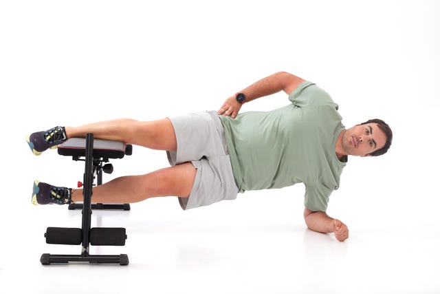 a man doing a push up on a stool