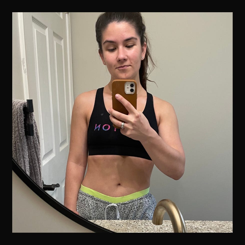 selfportrait in a bathroom setting showcasing athletic attire and accessories