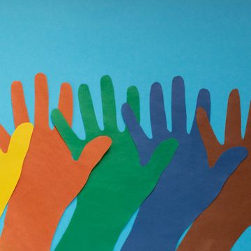 abstract background open multicolored paper palms on a blue backgroundthe concept of autism day and youth solidarity day