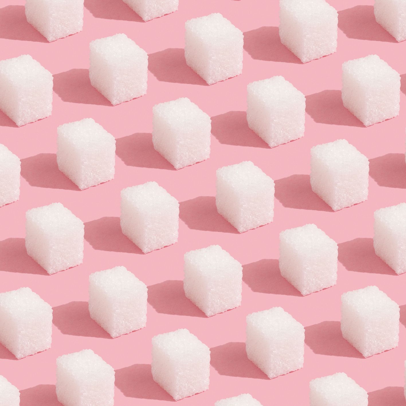 abstract pattern made of sugar cubes on pink minimal style background