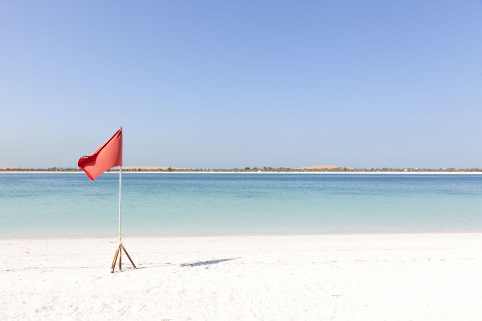 uae, abu dhabi, persian gulf, corniche, beach, red flag at the beach