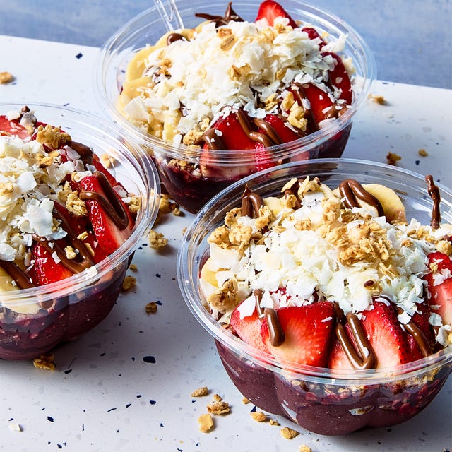 Acai Playa Bowl acai playa bowl topped with bananas, strawberries, coconut shreds, and granola