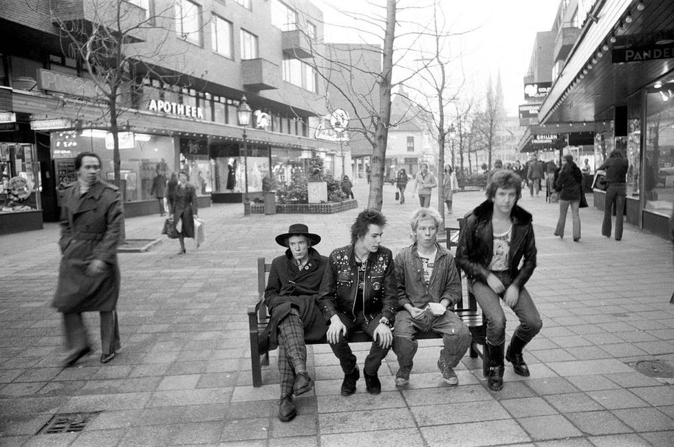 The Sex Pistols on a bench