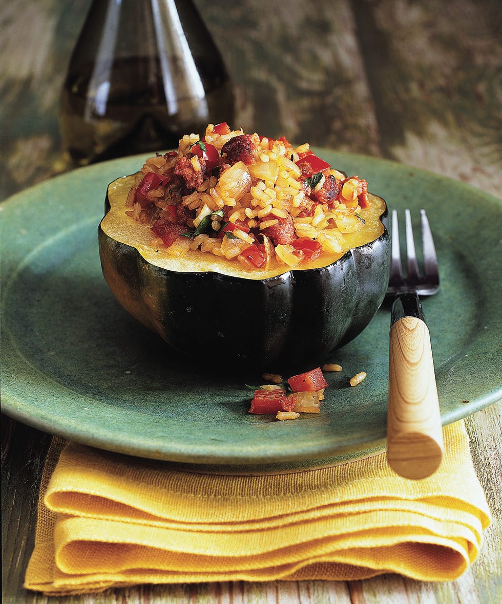 healthy acorn squash with brown rice and turkey sausage on a blue plate