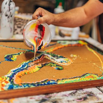 man pouring paint during an acrylic pouring project