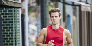 action portrait of caucasian male runner in urban setting