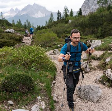 active caucasian man, hiking through dolomites