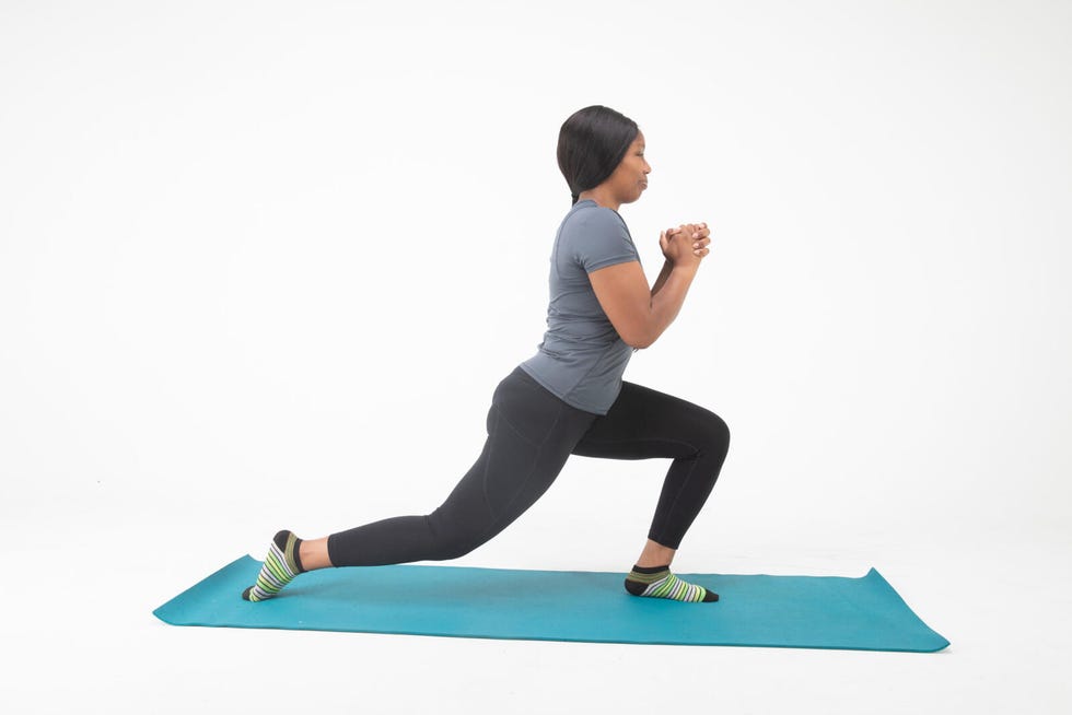 person performing a lunging exercise on a yoga mat