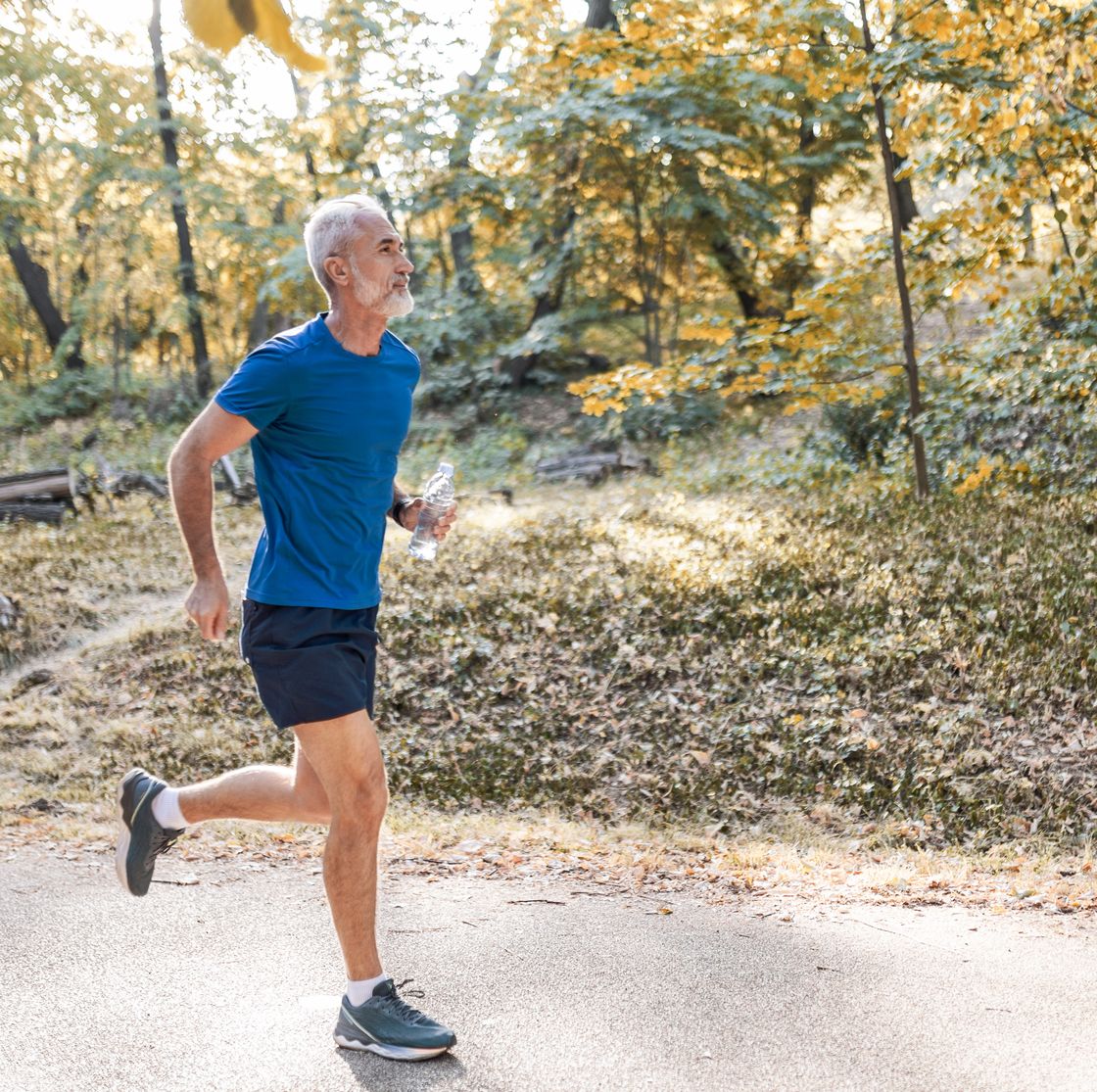 active senior man running in the park