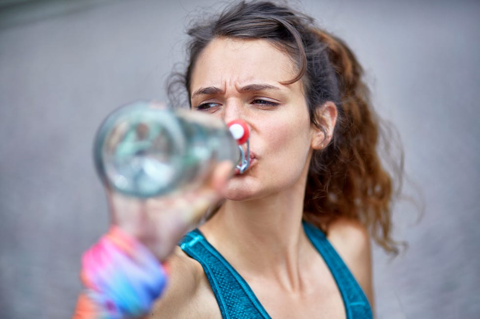 active woman drinking water from bottle
