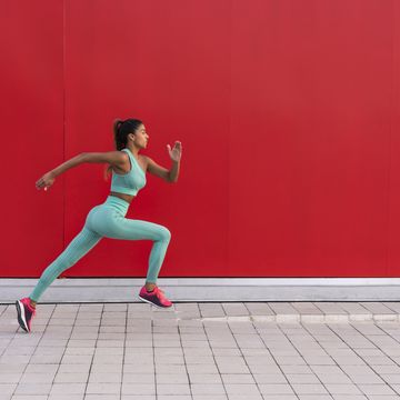 active woman running fast on street