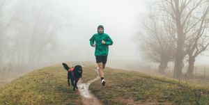 active young man jogging with his dog
