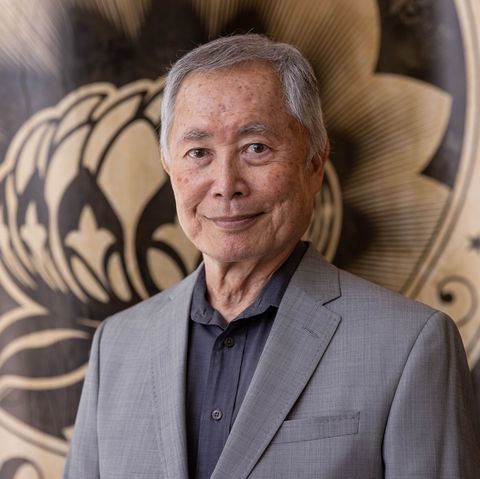 george takei smiles wearing gray suit
