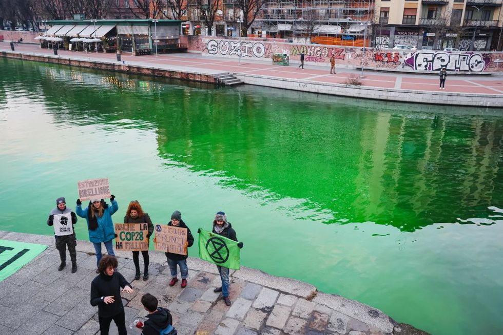 the water of the darsena colored green by the activists of extinction rebellion in milan