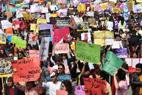 activists of the aurat march carry placards as they march during a rally to mark international women's day in lahore on march 8, 2020