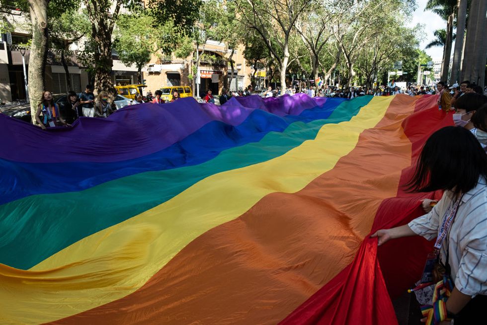 activists seen carrying a big rainbow flag during the 2020