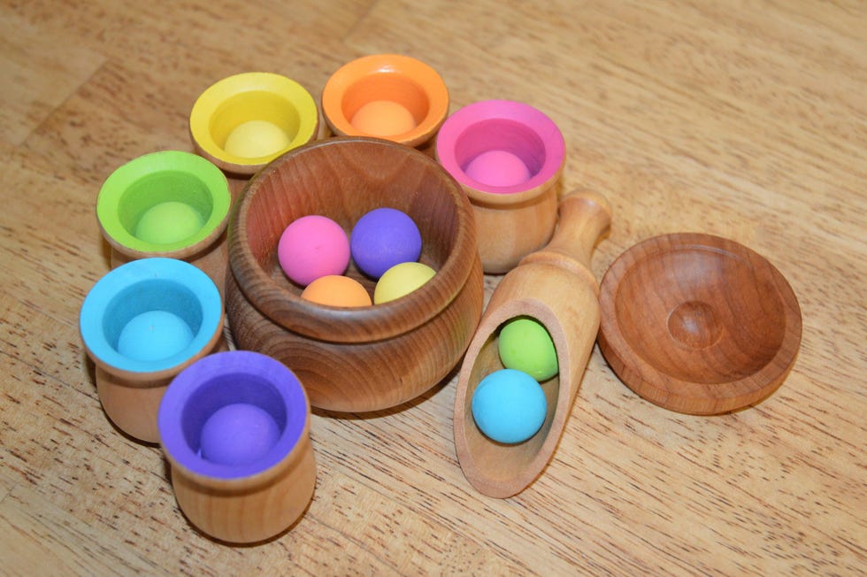 a set of colored cups and balls used for a sorting activity