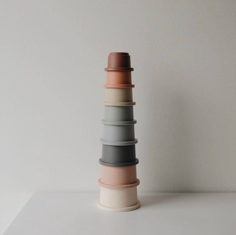 a set of stacked cups in muted colors