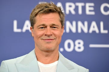 brad pitt smiles in light blue suit at movie premiere