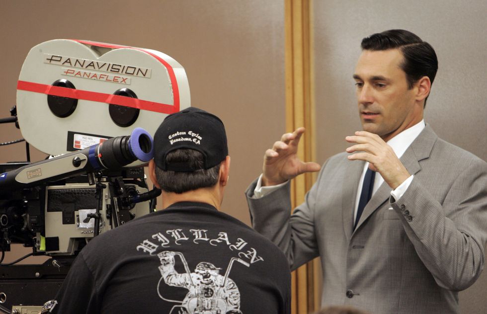 actor jon hamm, right, talks to a cameraman while on the set of mad men, a new amc series about ad
