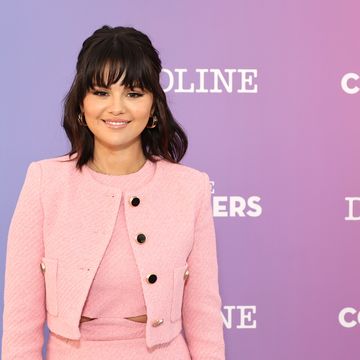 selena gomez on a red carpet in a pink suit