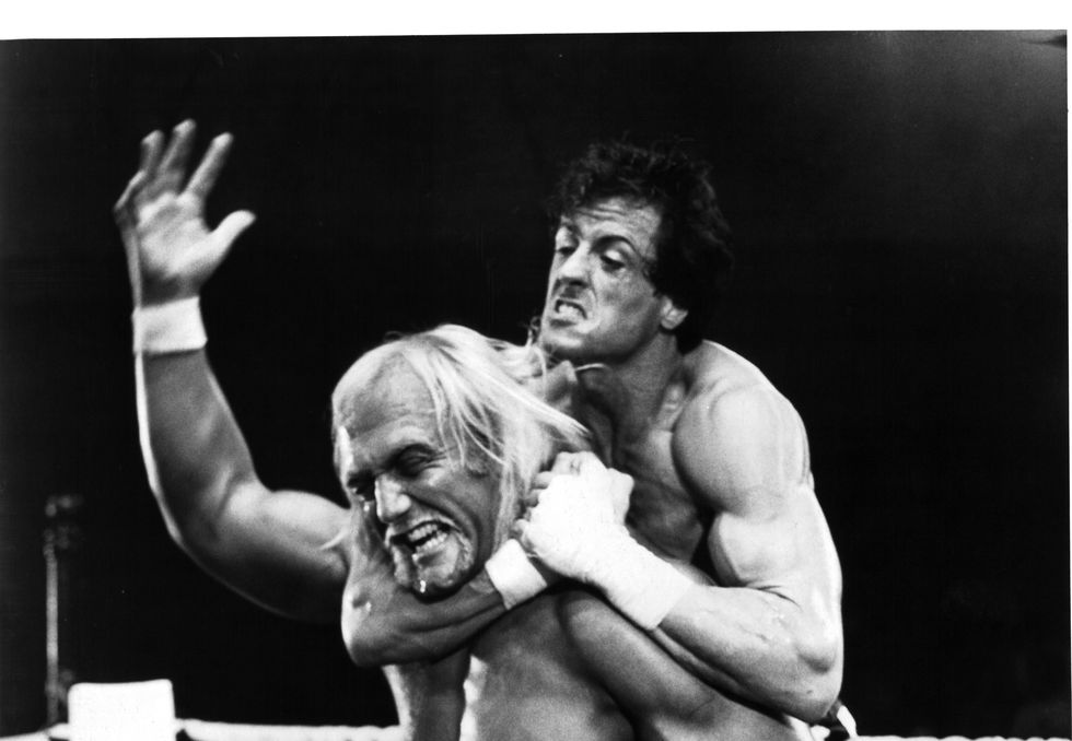 one man placing another in a chokehold inside a wrestling ring