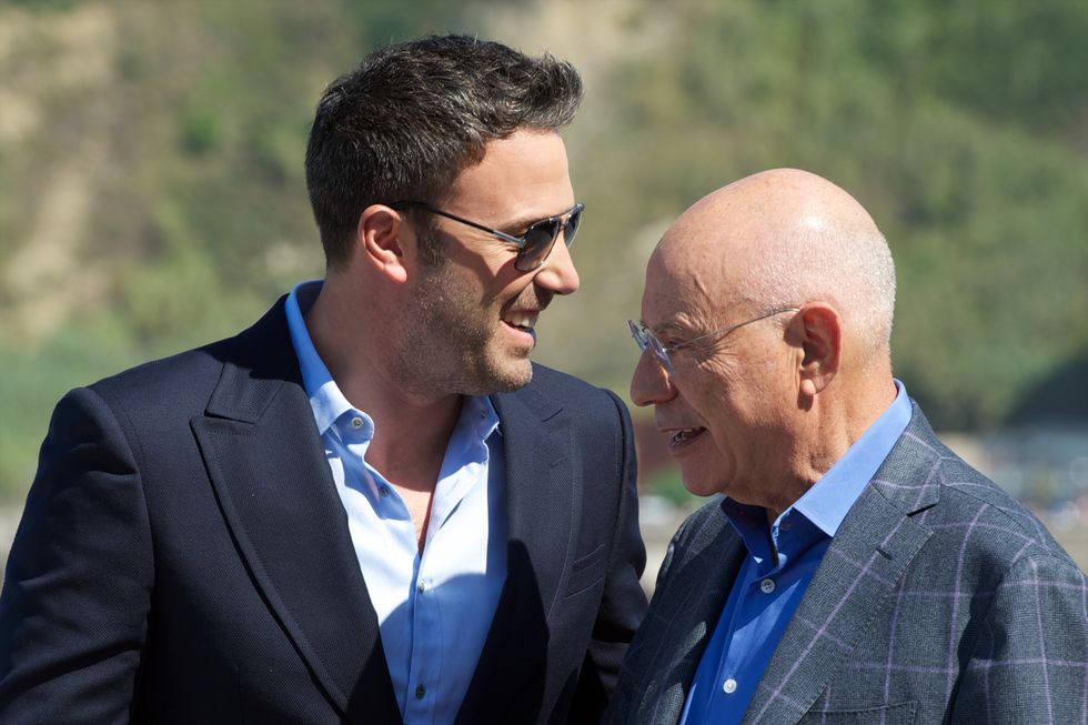 ben affleck and alan arkin wearing suits and smiling to each other