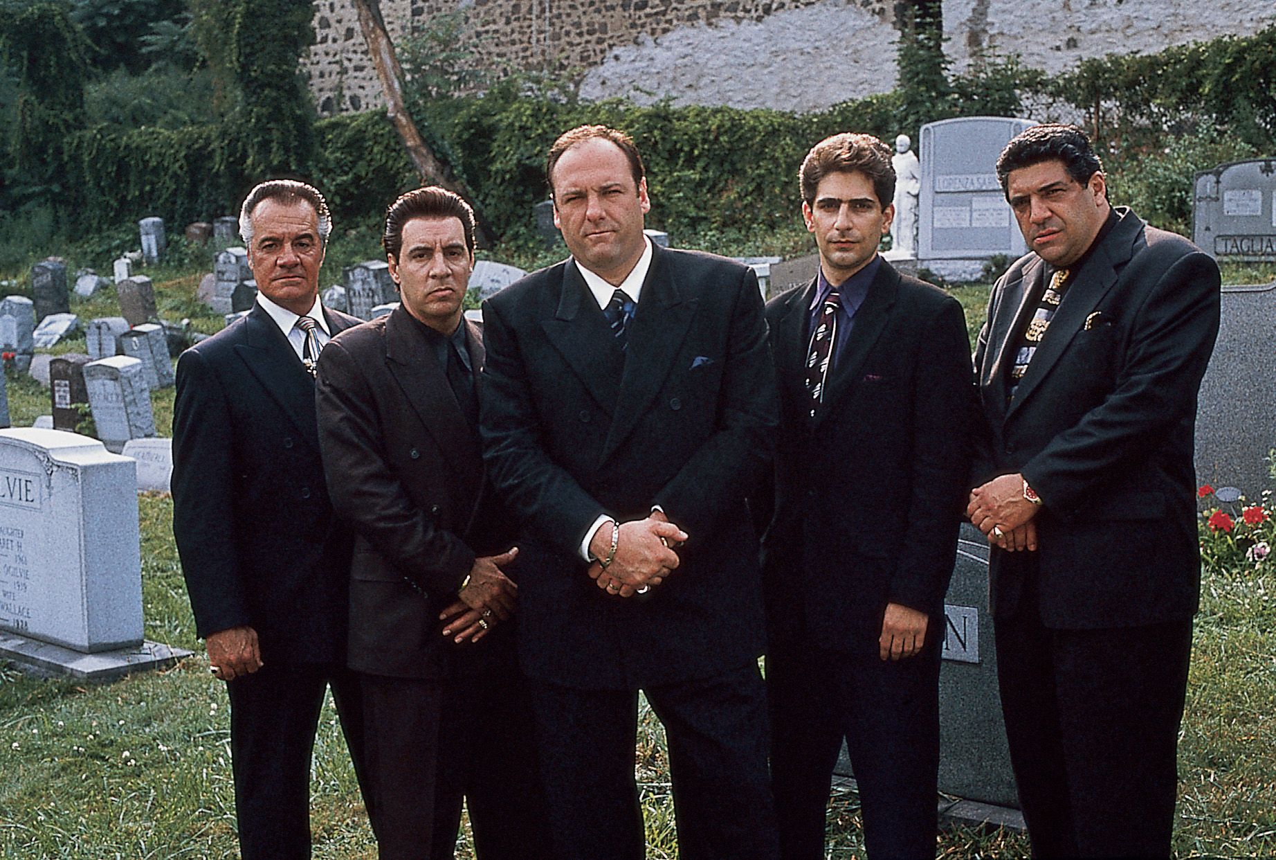 Still from "The Sopranos" with male cast standing in a cemetery.