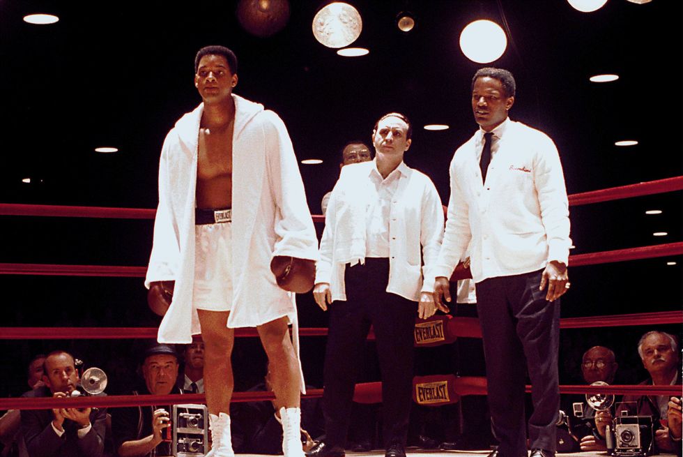 will smith, ron silver and jamie foxx stand in character inside a boxing ring, smith wears boxing gloves shorts and a robe