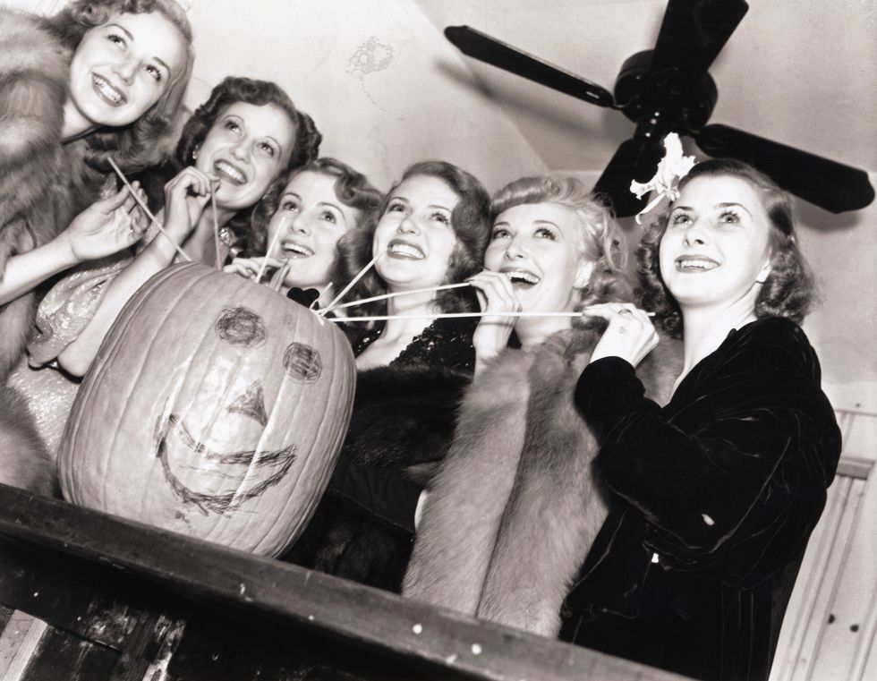 lana turner and friends drinking from a pumpkin