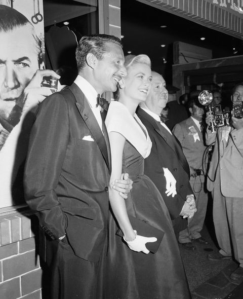 grace kelly, alfred hitchcock and oleg cassini getting their picture taken