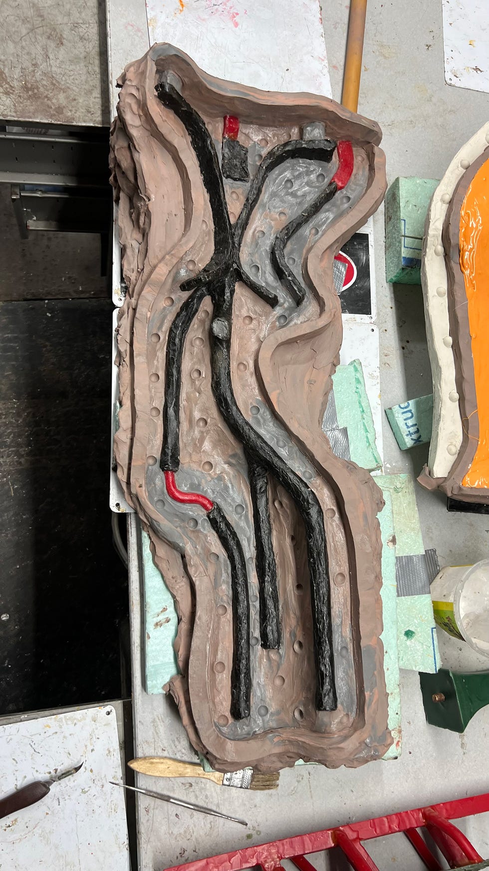 Mold with pathways for a casting process, displaying intricate contours and channels.