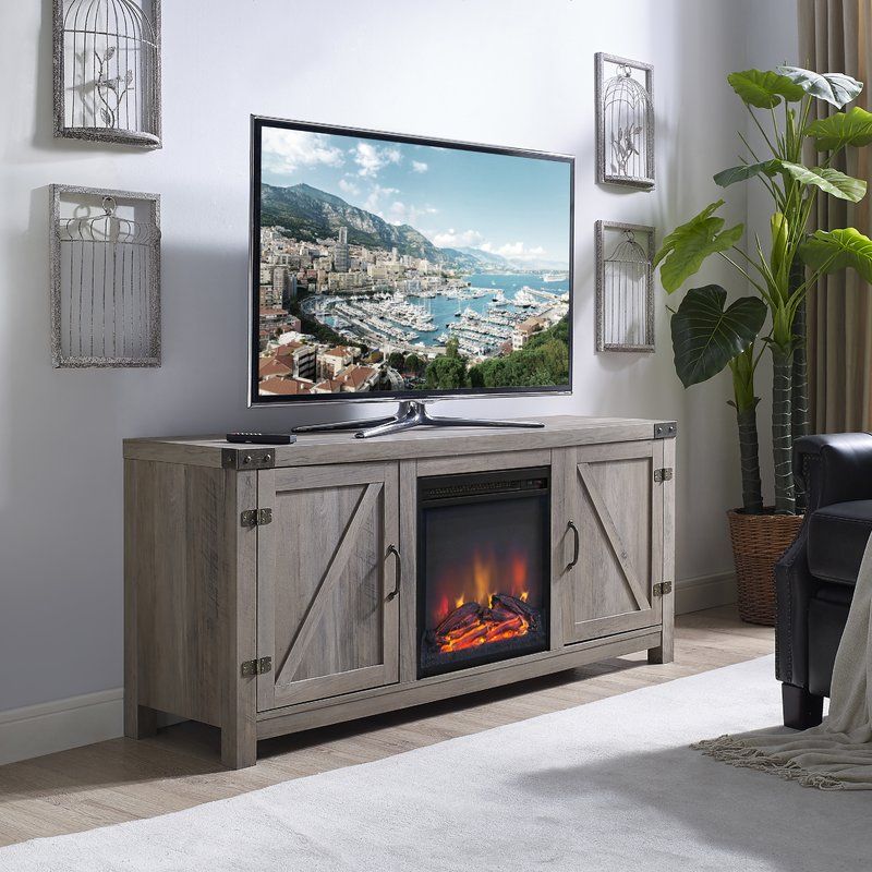 Adalberto tv stand with outlet fireplace