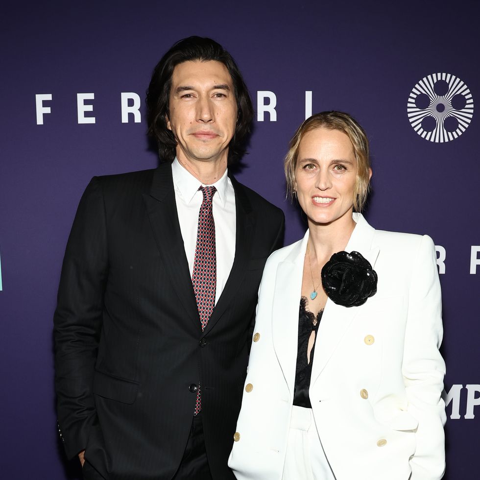adam ferrari and wife joanne tucker smiling for a red carpet photo at a film premiere