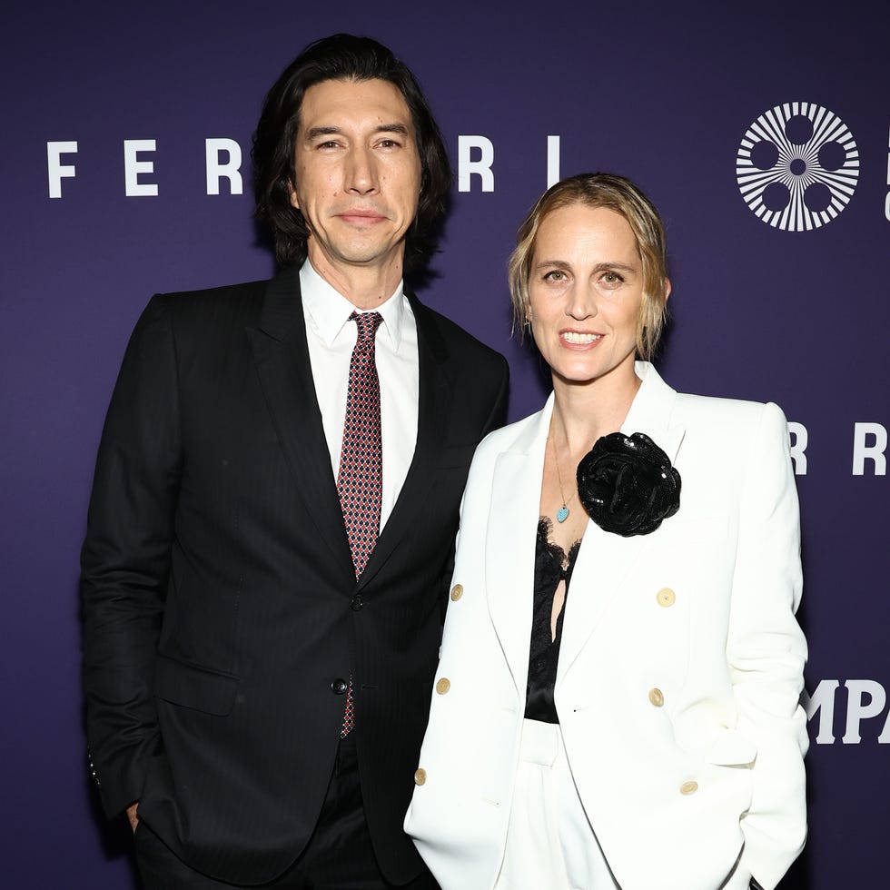 adam ferrari and wife joanne tucker smiling for a red carpet photo at a film premiere