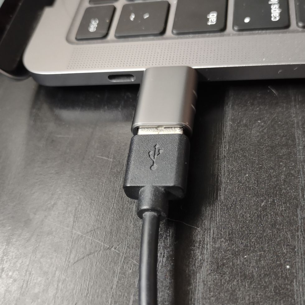 adapter plugged into side of macbook
