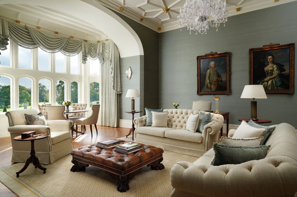 a living room with a chandelier and couches
